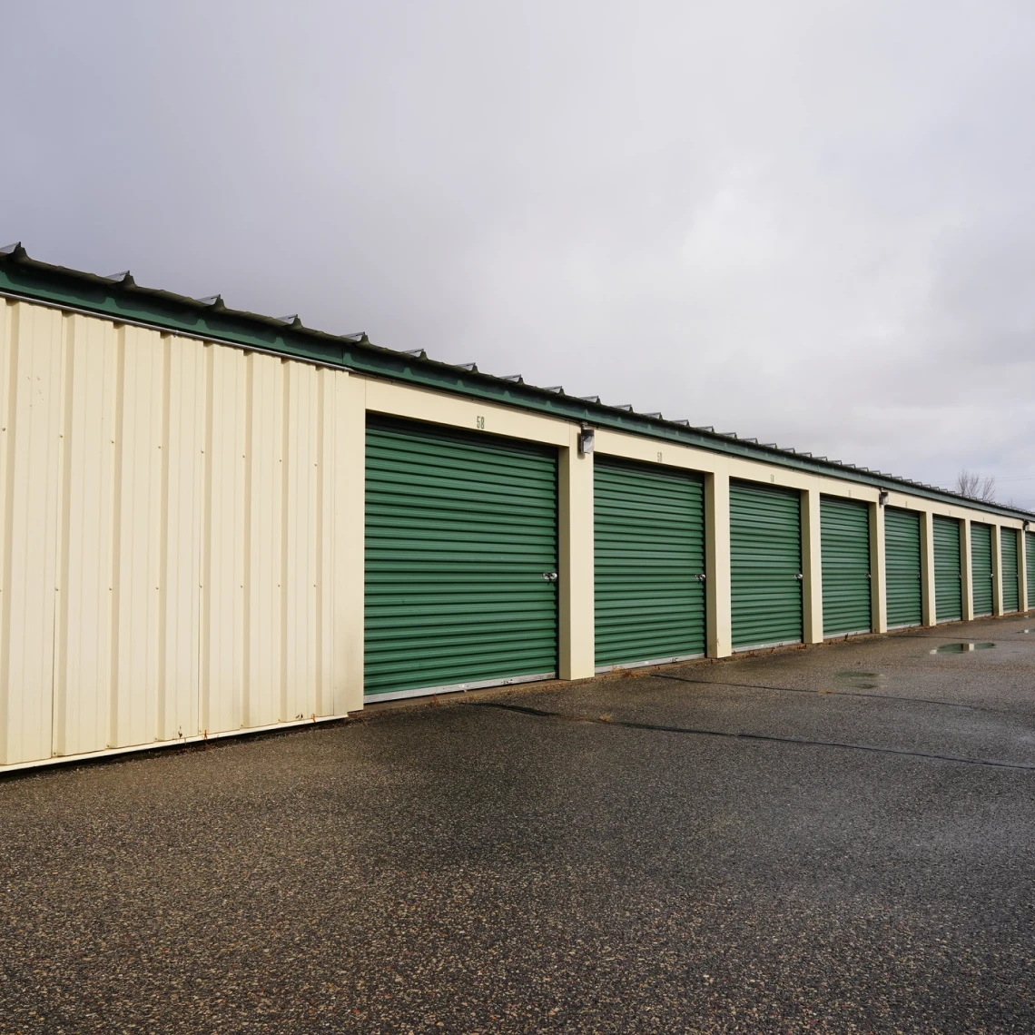 Row of green storage unit doors