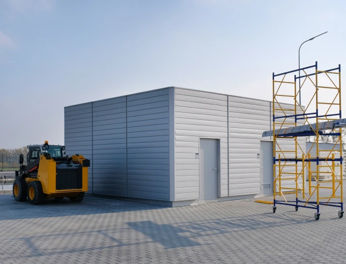 Warehouse exterior with machinery nearby